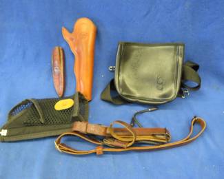 Lot 362. One leather holster, a leather sheath, a leather shooting accessories bag, and more