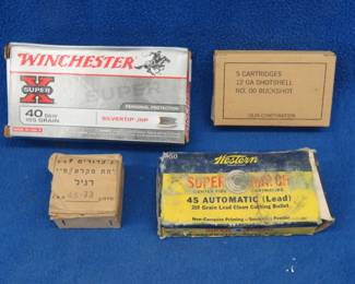 Lot 486. Four boxes of ammo: 25 unidentified rounds marked 10-73on the casing. 5 Olion 12-ga buckshot shotgun shells. Partial vintage box of Western Super Match 45 Auto rounds in poor condition. 50 Winchester 40 S&W rounds
