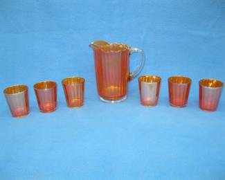 Lot 385. Marigold carnival glass pitcher with 6 glasses. No chips.