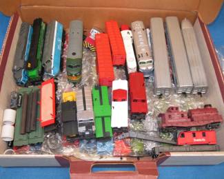 Lot 401. Large group of HO train cars. Includes at least 7 engines one of which is Bicentennial- themed. Also lighted cars and action cars.