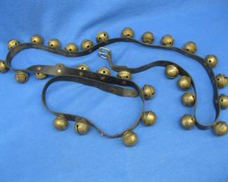 Lot 379. 90+ inch long brass sleigh bell set. One bell is missing.