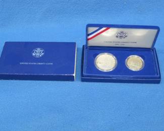 Lot 119. 1986 Statue of Liberty two-coin set with an 80% Silver Dollar and a clad Half Dollar coin
