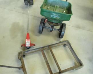 Lot 331. Heavy-duty pull cart, a seeder, and a weed whip with no charging cord