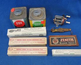 Lot 353. Many collectibles including two empty gun powder tins, a Bronson Veteran fishing reel, two checkering tools in boxes, two anti-rust ropes in. boxes, and more