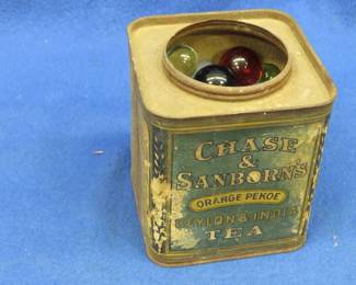 Lot 375. An old tea tin with marbles
