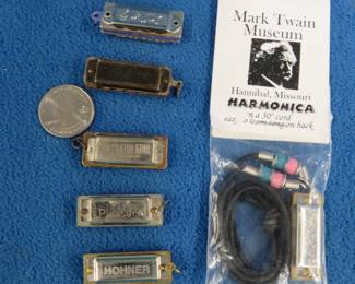 Lot 166. Six 1 3/8" novelty miniature harmonicas: Hohner Little Lady 1 3/8" 4-hole diatonic. Sounds great. Unbranded 5-hole. Poor sound. Unbranded 4-hole. Poor sound. Congratulator 5-hole diatonic. Sounds good.. Gustav Spranger My Pleasure 4-hole diatonic harmonica. Sounds fair.. Unopened mark Twain Museum Hohner 4-hole harmonica