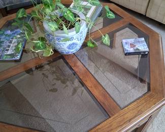 This octagonal glass and wood table has 4 glass inserts and was mad by a very well know furniture maker. It is in good condition and is 41 inches across.