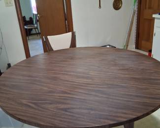 MCM Wooden look table with sturdy metal frame and legs with matching wood look on legs. It is extremely sturdy and has no damage . It would be Very hard to take apart .It is a 48 inch table .