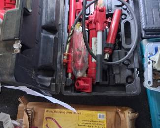 The equipment in red is a body frame adjuster, in case, brand new.