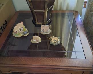 This is one of the 2 end table, in that same group the top is again glass and wood while the bottom shelf is woven basket weve pattern inside the wooden frame . It is 27 inches square.e