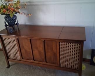MCM stereo cabinet . The radio on it still works but the turntable does not . It is in good condition and looks beautiful whether you use the stereo or not.