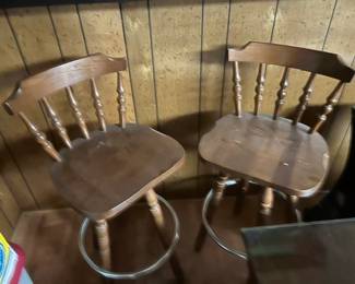 Pair of wooden Windsorstyle solid oak swivel bar stools with sturdy metal footrest