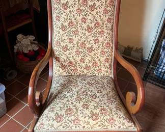 Mahogany Victorianstyle platform rocking chair wiht curved arms and floral fabric upholstery