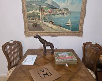 Versatile table can be either square or round, pair of wicker-backed side chairs and a beautiful framed canvas water scene
