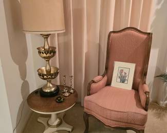 large vintage brass lamp (MCM), occasional table and an elegant Louis XV-style armchair.