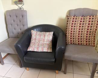 . . . black leather accent chair and two grey side chairs
