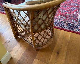 tage 1970s corbeille-style armchair features a rounded backrest, woven lattice framework, and bent rattan construction. It is a quintessential piece of mid-century tropical and boho-chic design, often referred to as a coastal or Palm Beach Regency accent chair.