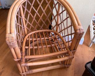 tage 1970s corbeille-style armchair features a rounded backrest, woven lattice framework, and bent rattan construction. It is a quintessential piece of mid-century tropical and boho-chic design, often referred to as a coastal or Palm Beach Regency accent chair.