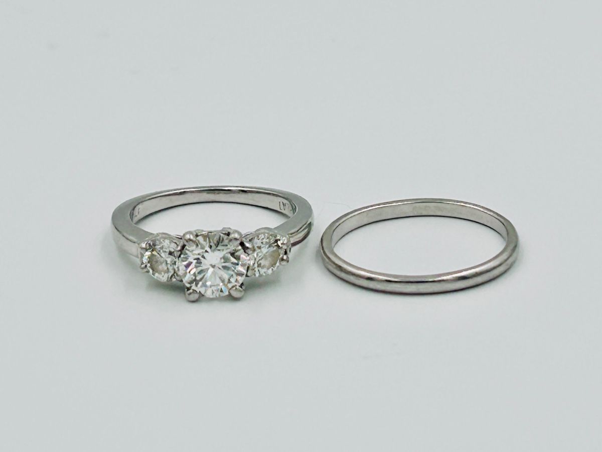 One Platinum ring set with a center brilliant cut genuine diamond weighing 1.16 carat. The diamond is GIA graded “G” color and “VS-2” clarity. Report #5126044913. The diamond is cut excellent. The center diamond is flanked on each side by a brilliant cut genuine diamond weighing .86 carat total weight. The side diamonds are ‘G’ Color and “VS” clarity.