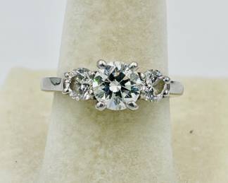 One Platinum ring brilliant cut genuine diamond weighing 1.16 carat. The diamond is GIA graded “G” color and “VS-2” clarity. Report #5126044913. The diamond is cut excellent. The center diamond is flanked on each side by a brilliant cut genuine diamond weighing .86 carat total weight.