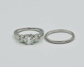 One Platinum ring set with a center brilliant cut genuine diamond weighing 1.16 carat. The diamond is GIA graded “G” color and “VS-2” clarity. Report #5126044913. The diamond is cut excellent. The center diamond is flanked on each side by a brilliant cut genuine diamond weighing .86 carat total weight. The side diamonds are ‘G’ Color and “VS” clarity.