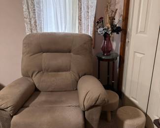 Tan Upholstered Recliner  Comfortable tan upholstered recliner with a high padded back, cushioned seat, and wide padded arms. A cozy addition to a living room, den, bedroom, or reading area.