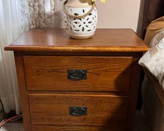 Two-Drawer Wood End Table  Sturdy wood end table featuring two spacious drawers with dark metal handles and a warm natural finish. A practical piece for a bedroom, living room, or guest room, with plenty of storage for everyday items.