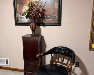 Black Leather Accent Chair and Jewelry Chest  Classic black leather accent chair with curved wooden arms and spindle details, paired with a tall wooden jewelry chest featuring multiple drawers for organized storage. Both pieces work well in a bedroom, dressing area, office, or sitting room.