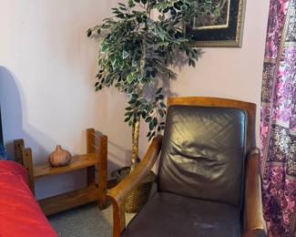 Classic brown leather accent chair with a high back, cushioned seat, and exposed wooden arms and legs. Its simple, traditional style makes it a good fit for a bedroom, office, reading corner, or living room.