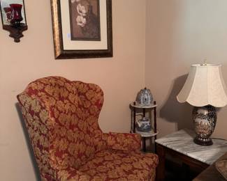 Red and Gold Upholstered Accent Chair  Traditional high-back accent chair featuring an elegant red-and-gold floral pattern, cushioned seat, and rounded arms. A comfortable statement piece for a living room, bedroom, office, or reading corner.