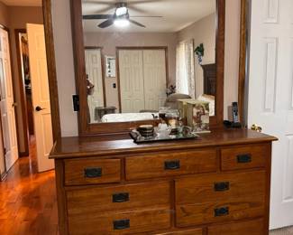Beautiful solid wood dresser featuring six spacious drawers and a large framed mirror. The warm wood finish and dark metal handles give it a classic, sturdy look. Great for a bedroom, guest room, or furniture restoration project.