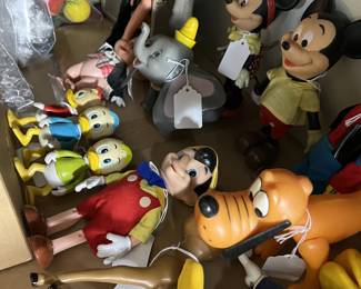 Collection of vintage Disney character toys and figures, including Mickey Mouse, Donald Duck, Goofy and Pluto.