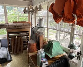 Rustic cabin décor, vintage camping gear, lanterns, metalware, vintage life jackets, and outdoor accessories.