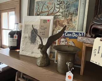 Eclectic vintage décor, collectible advertising pieces, beer signs, and framed artwork.