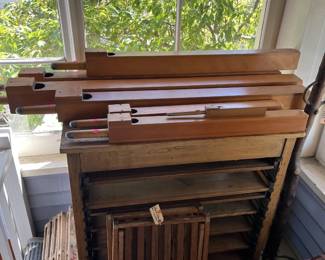 Folding wooden chair, vintage letterpress wood cabinet and vintage organ pipes.