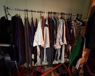 Multiple racks of clothing. Mostly men's but some women's.