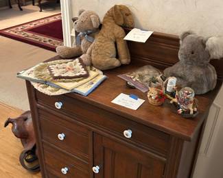 Vintage table; pins; vintage stuffed animals; needlepoint pieces