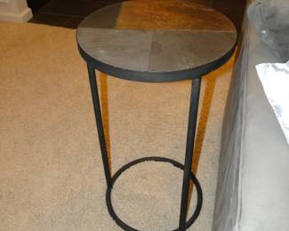 A pair of round side tables with tile tops