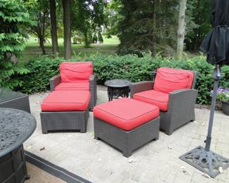 Pair of comfortable relaxing chairs with matching ottomans