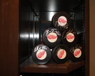 More signed Red Wings hockey pucks