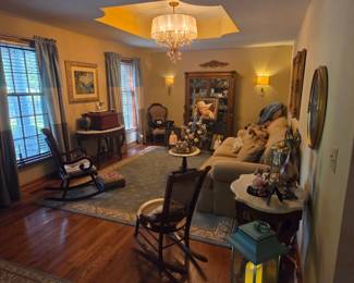 Room full of beautiful antique items and modern couch