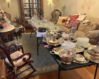 Antique chairs and marble top tables. Crystal and cut glass. Silver plated serving dishes. Pillows