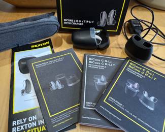 Rexton bicore hearing aid complete set to include RT and LT hearing aid, charger, charger port, case, carrying case and original pamphlets