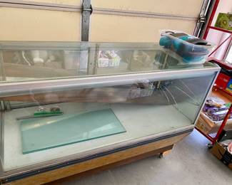 Display case on wheels, broken glass panel