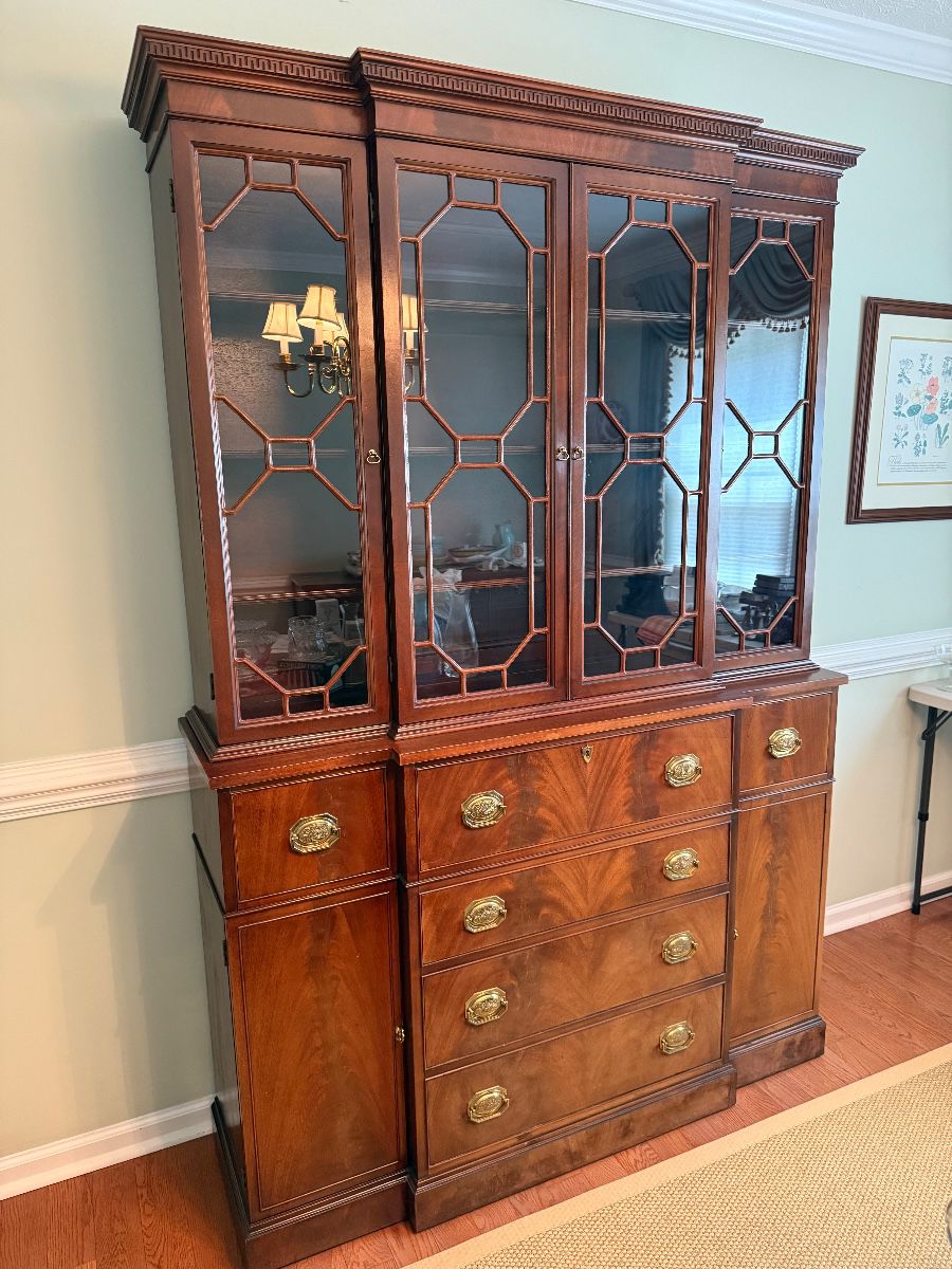 Beautiful flame mahogany China cabinet. Top center drawer drops down to reveal a built in desk.