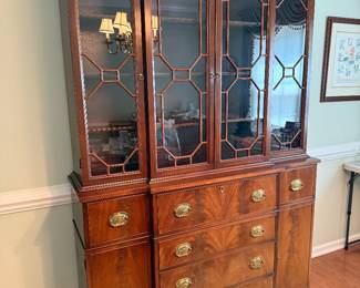 Beautiful flame mahogany China cabinet. Top center drawer drops down to reveal a built in desk.