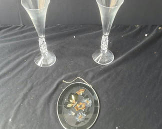 Lot 59: Two crystal champagne flutes and an oval enamel floral butterfly hanging ornament