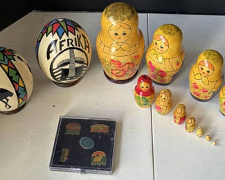 Lot 221: Matryoshka nesting dolls with decorative eggs and Alaska souvenir stickers