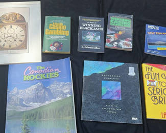 Lot 24: Travel guides, gambling books, and a clock print