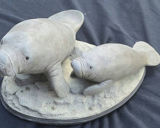 Lot 20: Two Manatee Sculptures on an Oval Base